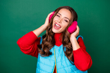 Poster - Photo of pretty cute young lady dreamy look open mouth pretend listen music favorite singer sing song wear pink ear warmers blue vest red sweater isolated green color background