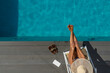 © Netfalls - woman at spa resort by the swimming pool.