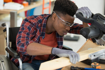 wheelchair bound man using a circular saw