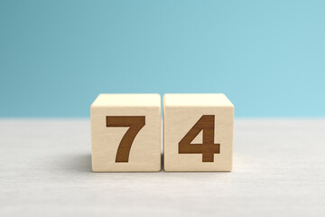 Wall Mural - Wooden toy blocks forming the number 74.