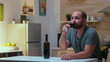 © DC Studio - Lonely husband drinking a glass of wine at home. Unhappy person suffering of migraine, depression, disease and anxiety feeling exhausted with dizziness symptoms having alcoholism problems.