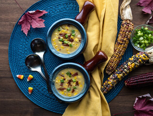 Wall Mural - Top down view of soup crocks filled with corn chowder ready for eating.