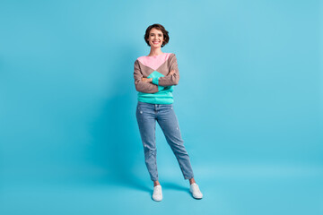 Poster - Photo portrait full body of cheerful girl standing with folded hands isolated on pastel light blue colored background