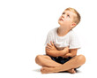 Litlle boy sitting on the floor and looking up on white background