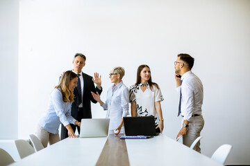 Senior businesswoman working together with young business people in office