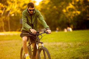 Wall Mural - Young man riding ebike in the park