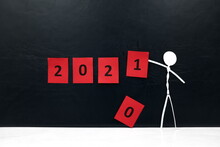 Stick Man Figure Changing 2020 Year Red Cubes To 2021 In Black Background With Copy Space. New Year Celebration Concept.
