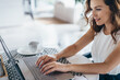 © undrey - Young beautiful woman using a laptop computer at home