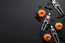 Happy Halloween Banner Mockup. Flat Lay Composition With Skeletons, Pumpkins, Bats On Black Background. Top View With Copy Space.