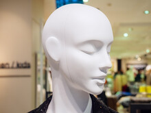 Head Of White Female Mannequin On Blurred Shop Background