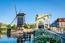 Classic Dutch Scene With Drawbridge And Windmill In The City Of Leiden, Holland