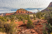 A Formation Of Red Sandstone Rock Sand Juniper Trees Under A Buttermilk Sky, Outside The City Of Sedona, Arizona