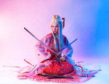 A Woman Dressed As A Geisha With A Katana