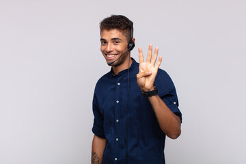 Wall Mural - young telemarketer man smiling and looking friendly, showing number four or fourth with hand forward, counting down