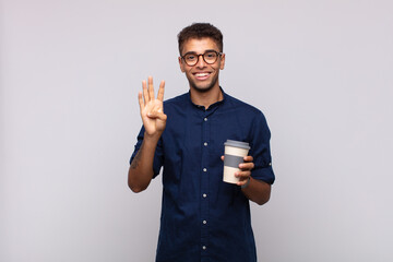 Wall Mural - young man with a coffee smiling and looking friendly, showing number four or fourth with hand forward, counting down