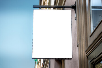 Mock up. Blank white signboard on the wall of classical architecture building