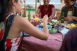 © Trevor Adeline/Caia Image - Young friends eating tacos at patio table