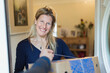 © Paul Bradbury/Caia Image - Portrait smiling woman receiving delivery at front door