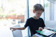 © Paul Bradbury/Caia Image - Boy looking at photo album