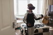 © Paul Bradbury/Caia Image - Boy playing video game with VRS goggles in living room
