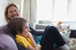 © Paul Bradbury/Caia Image - Portrait happy mother and son on living room sofa