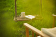 © Martin Barraud/Caia Image - Coffee and book on swing in idyllic garden