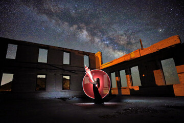 Wall Mural - Beautiful Model Posing in the Desert at Night With Milky Way