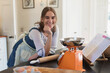 © Sam Edwards/Caia Image - Portrait happy teenage girl baking in kitchen