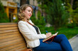 Portrait of young beautiful woman relaxing on the bench