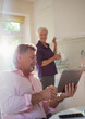 © Tom Merton/Caia Image - Senior couple with digital tablet talking in kitchen
