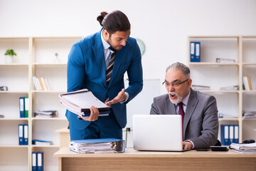 Two male colleagues working in the office