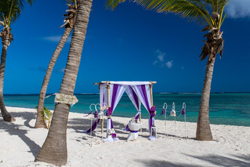 Sticker - Wedding bamboo gazebo, decorated with tropical flowers and coloured fabrics on the paradise beach with palm trees, white sand and blue water of Caribbean Sea, Punta Cana, Dominican Republic 