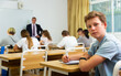 © JackF - Portrait of confident teenage student sitting on lesson in classroom, looking at camera