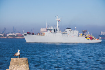 Wall Mural - Patrol boat and sea port Varna, Bulgaria. Industrial cranes, ships and boats on the harbour