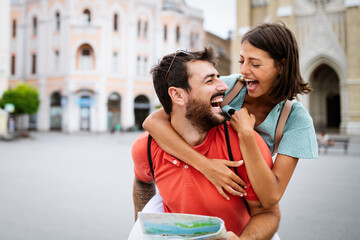Wall Mural - summer holidays, dating and tourism concept. smiling couple walking with map in the city