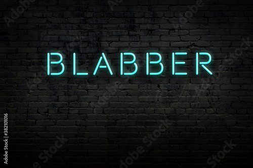 Fotomural Night view of neon sign on brick wall with inscription blabber