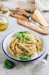 Wall Mural - Tagliatelle pasta with pesto sauce and basil leafs.