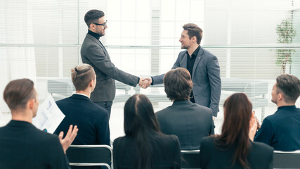 Wall Mural - happy colleagues shaking hands with each other.