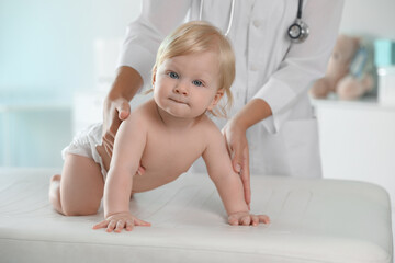 Poster - Pediatrician examining baby in hospital. Health care