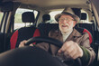 © deagreez - Close-up portrait of his he nice experienced cheerful cheery glad grey-haired man driving car in traffic jam holding steering wheel enjoying far way road