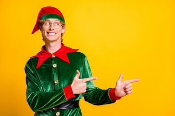 Poster - Portrait of his he nice attractive glad cheerful cheery funny guy elf showing copy space advert ad novelty gift present surprise isolated over bright vivid shine vibrant yellow color background