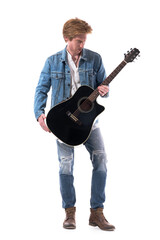 Cool stylish red hair country music guitarist holding acoustic guitar wearing jeans. Full body isolated on white background.