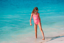 Adorable Little Girl Have Fun At Tropical Beach During Vacation