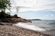© Brad - Long exposure of waves crashing over rocky shore in northern Michigan