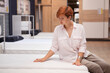 © mad_production - Attractive female customer examining new orthopedic bed on sale at furniture store, copy space