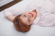 © mad_production - Top view close up of a happy relaxed woman enjoying lying on orthopedic mattress
