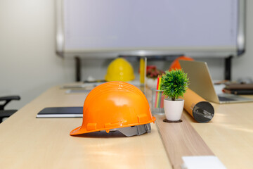 Close up of helmet and etc. on architect desk, architectural concept.