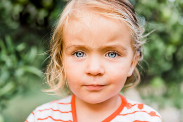 Wall Mural - Toddler girl portrait in garden