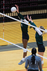 Young girl playing in a competitive volleyball match