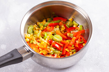 Stewed vegetables in a saucepan. Close-up vegetable stew in a saucepan. Healthy food concept. Vegetarian food concept